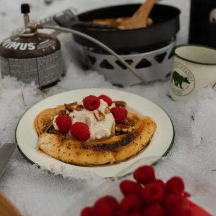 American pancakes with caramelized bananas, pecan nuts and peanut cream